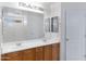 Clean bathroom featuring a double vanity, large mirror, and neutral finishes at 43232 W Magnolia Rd, Maricopa, AZ 85138