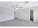 Bedroom with neutral walls, soft carpet, and access to a closet and en-suite bathroom at 43232 W Magnolia Rd, Maricopa, AZ 85138