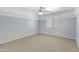 Bright bedroom with a ceiling fan and neutral carpet at 43232 W Magnolia Rd, Maricopa, AZ 85138