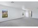 Spacious bedroom with large windows offering natural light, and soft carpet at 43232 W Magnolia Rd, Maricopa, AZ 85138