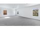 Bonus room with ample natural light and neutral carpeting at 43232 W Magnolia Rd, Maricopa, AZ 85138