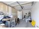 Cluttered garage with white walls, storage and concrete floors at 43232 W Magnolia Rd, Maricopa, AZ 85138