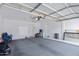 Spacious garage with white walls, storage and concrete floors at 43232 W Magnolia Rd, Maricopa, AZ 85138