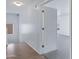 Hallway landing with luxury vinyl flooring, leading to carpeted bedrooms at 43232 W Magnolia Rd, Maricopa, AZ 85138