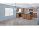 Bright kitchen featuring wood cabinets, an island, and modern appliances for a functional space at 43232 W Magnolia Rd, Maricopa, AZ 85138