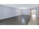Spacious living room featuring stylish flooring and bright neutral walls at 43232 W Magnolia Rd, Maricopa, AZ 85138