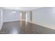Bright living area with hardwood floors, neutral paint, and open layout at 43232 W Magnolia Rd, Maricopa, AZ 85138