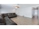 Large living room with wood-look floors, a sectional sofa, and ample open space at 43232 W Magnolia Rd, Maricopa, AZ 85138