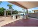 Covered outdoor kitchen with barbecue area, a gazebo, and a stamped concrete patio at 43232 W Magnolia Rd, Maricopa, AZ 85138
