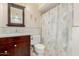 Cozy bathroom featuring a single vanity and a shower with a floral shower curtain at 4716 W Hayward Ave, Glendale, AZ 85301