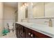 Bathroom featuring double sinks, a quartz countertop, and modern fixtures at 4716 W Hayward Ave, Glendale, AZ 85301