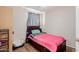 Simple bedroom featuring wood flooring, large bed, and ample natural light at 4716 W Hayward Ave, Glendale, AZ 85301