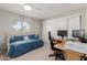 Bedroom featuring a daybed, white sliding closet doors, and dedicated workspace at 4716 W Hayward Ave, Glendale, AZ 85301
