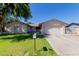 Charming single-story home featuring a well-maintained lawn, mature tree, and a two-car garage at 4716 W Hayward Ave, Glendale, AZ 85301
