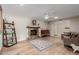 Spacious living room with wood floors, a ceiling fan, and a stone fireplace at 4716 W Hayward Ave, Glendale, AZ 85301