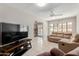 Cozy living room with tile flooring, ceiling fan, and an open view to the kitchen and pool at 4716 W Hayward Ave, Glendale, AZ 85301