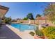 Refreshing pool with slide, surrounded by well-maintained landscaping and vibrant flowers at 4716 W Hayward Ave, Glendale, AZ 85301