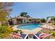 Sparkling pool with slide, lounge chairs, and lush landscaping perfect for relaxation at 4716 W Hayward Ave, Glendale, AZ 85301