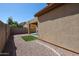 Spacious backyard features rock landscape, a small patch of grass, and a glimpse of a refreshing pool at 5323 E Hopi Ave, Mesa, AZ 85206