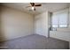 Bedroom featuring carpet, neutral paint, a ceiling fan, and a window seat at 5323 E Hopi Ave, Mesa, AZ 85206