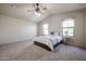 Relaxing bedroom with plush carpet, natural light, and ceiling fan at 5323 E Hopi Ave, Mesa, AZ 85206