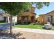 Charming tan two-story home with a well-maintained lawn, sidewalk, and mature landscaping for enhanced curb appeal at 5323 E Hopi Ave, Mesa, AZ 85206