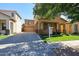 Inviting two-story tan home with a long driveway leading to a spacious garage and manicured front yard at 5323 E Hopi Ave, Mesa, AZ 85206