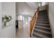 Bright interior showcasing an open floor plan, staircase, tile flooring, and a glimpse of the kitchen at 5323 E Hopi Ave, Mesa, AZ 85206