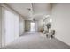 Bright living room with carpet, a ceiling fan, and a sliding glass door to the backyard at 5323 E Hopi Ave, Mesa, AZ 85206