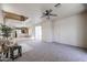 Inviting living room featuring plush carpet, ceiling fan, and staircase at 5323 E Hopi Ave, Mesa, AZ 85206