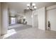 Open living space with neutral carpet, tile flooring, and natural light at 5323 E Hopi Ave, Mesa, AZ 85206