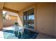 Inviting covered patio features a dining set on a vibrant rug, perfect for relaxation and outdoor enjoyment at 5323 E Hopi Ave, Mesa, AZ 85206