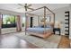 Primary bedroom with a four-poster bed, ceiling fan, and large windows at 5406 E Charleston Ave, Scottsdale, AZ 85254