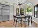 Dining area featuring contemporary lighting, stainless steel refrigerator, and backyard views at 5406 E Charleston Ave, Scottsdale, AZ 85254