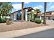 Inviting single-story home with desert landscaping, including a large arched window and stone details at 5406 E Charleston Ave, Scottsdale, AZ 85254
