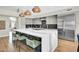 Bright kitchen with a waterfall island, pendant lighting, and stainless steel appliances at 5406 E Charleston Ave, Scottsdale, AZ 85254