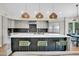 Modern kitchen with a large island, pendant lighting, and stainless steel appliances at 5406 E Charleston Ave, Scottsdale, AZ 85254