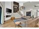 Open living room showcasing a fireplace, stylish decor, wood floors, and access to a staircase at 5406 E Charleston Ave, Scottsdale, AZ 85254