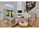 Inviting living room features a cozy fireplace, modern decor, and sliding glass doors to the backyard at 5406 E Charleston Ave, Scottsdale, AZ 85254
