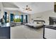 Spacious main bedroom with a vaulted ceiling, large windows, seating area, and luxury furnishings at 5406 E Charleston Ave, Scottsdale, AZ 85254