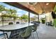 Spacious covered patio with ceiling fans, a large dining table, and backyard views at 5406 E Charleston Ave, Scottsdale, AZ 85254