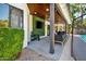 Covered patio featuring dark wood, black furniture, outdoor lighting, and a mounted TV at 5406 E Charleston Ave, Scottsdale, AZ 85254