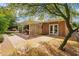 Beautiful backyard featuring stone pavers, furniture, grass, and mature tree at 5528 E Virginia Ave, Phoenix, AZ 85008