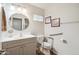 Accessible bathroom features safety bars, hand-held shower, and comfort height toilet at 5528 E Virginia Ave, Phoenix, AZ 85008