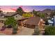 Charming home with beautiful landscaping and desert foliage, all set against a mountain backdrop at sunset at 5528 E Virginia Ave, Phoenix, AZ 85008