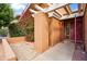 Inviting front entrance with decorative brickwork and a blooming bougainvillea bush at 5528 E Virginia Ave, Phoenix, AZ 85008