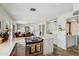 Open concept kitchen flowing into the living room, featuring stone tile flooring and stainless steel appliances at 5528 E Virginia Ave, Phoenix, AZ 85008