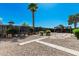 Well-maintained backyard with desert landscaping, stone pavers, gravel, and outdoor dining space at 5625 E Dodge St, Mesa, AZ 85205