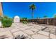 Backyard with large stone pavers, low-maintenance gravel, small storage shed, and lush desert landscaping at 5625 E Dodge St, Mesa, AZ 85205