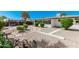 Enjoy the landscaped backyard with gravel, stone features, screened-in porch and outdoor dining at 5625 E Dodge St, Mesa, AZ 85205
